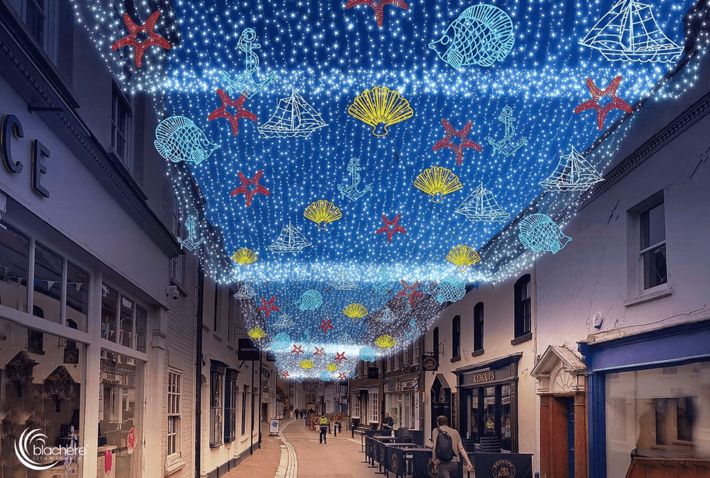 Fairy light carpet overhead town street with nautical themed lights (seashells, boats etc)