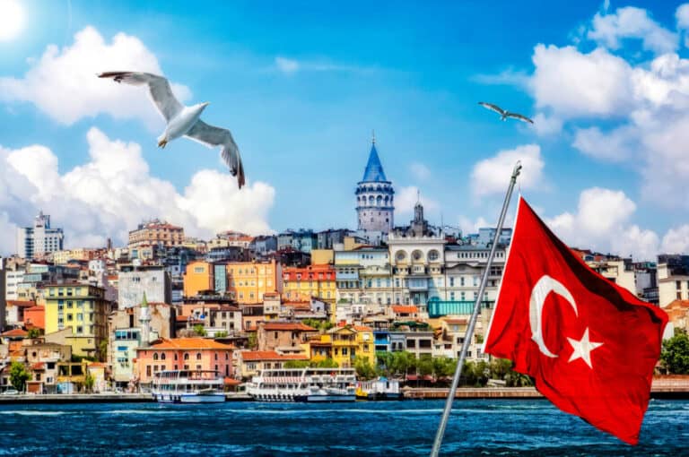 View of Istanbul city skyline from harbour with Turkish flag flying in the foreground