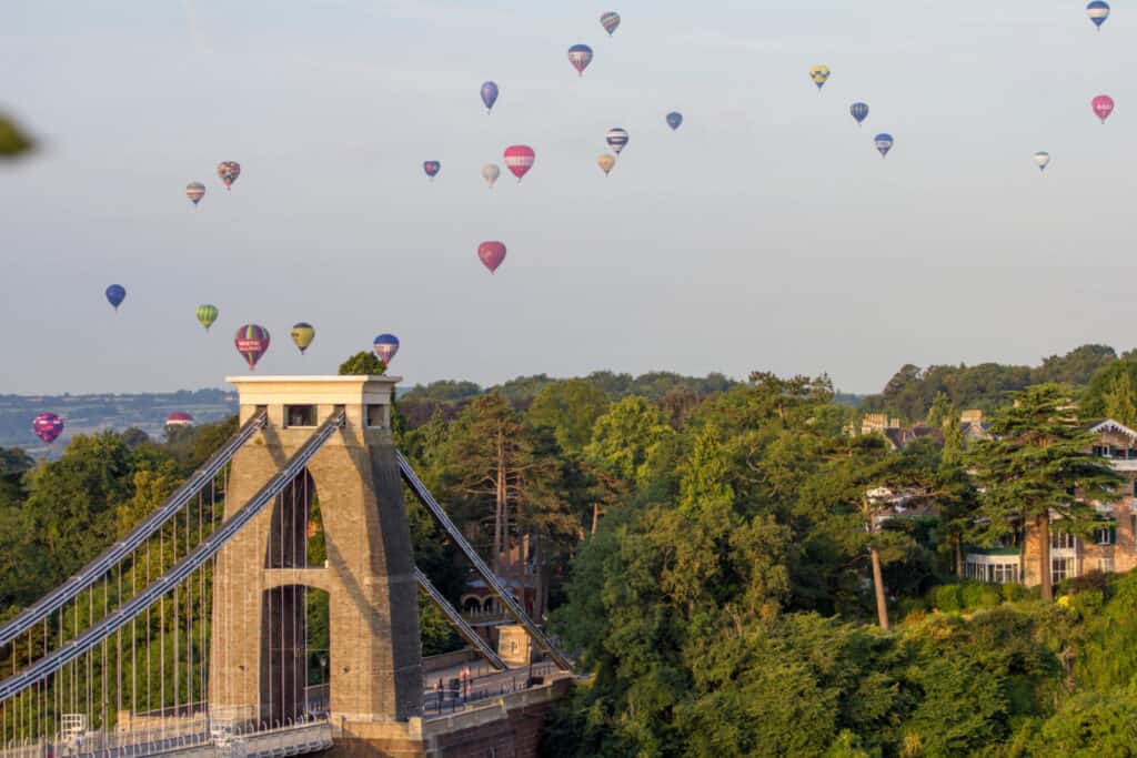 Hot air balloons flying over Clifton Suspension Bridge in Bristol