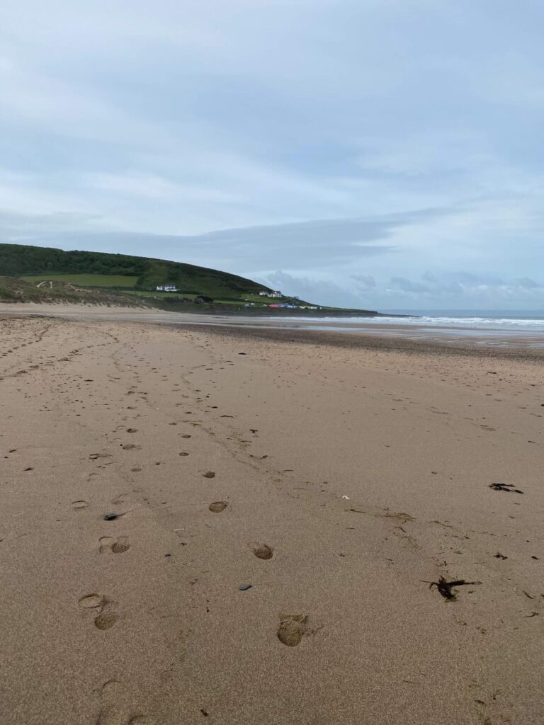 Footprints in the sand on Croyde Beach in North Devon