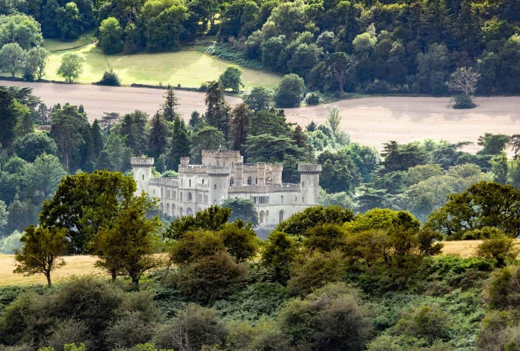 Historic landmark,nestled in a valley amidst beautiful lush,green summertime foliage,meadows and pastures,in rural scenery, typical of the west of England.A popular British tourist destination.
