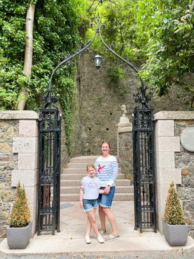 Mother and daughter stood in decorative gate in Rozel, Jersey