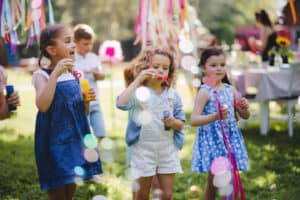 Girls blowing bubbles at summer event