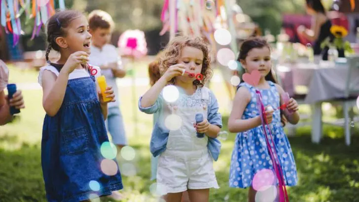 Girls blowing bubbles at summer event