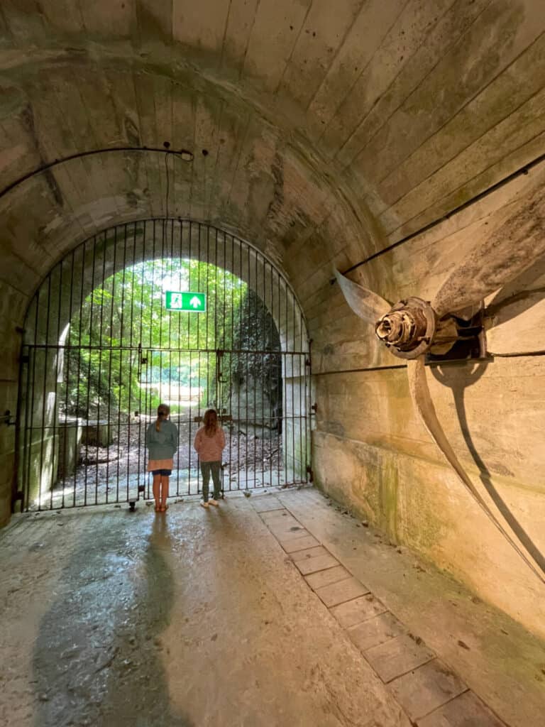 Children silhouetted against gate in Jersey War Tunnels