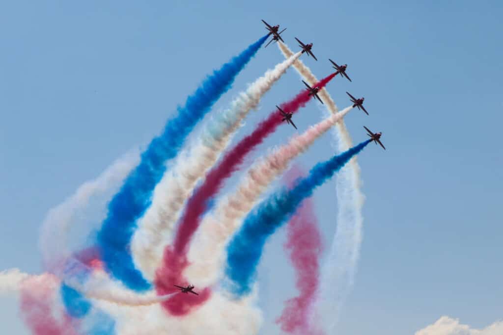 Red Arrow display team flying against blue sky