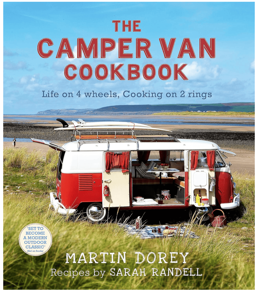 Front cover of The Camper Van Cookbook which has a picture of an old VW camper van parked on a beach