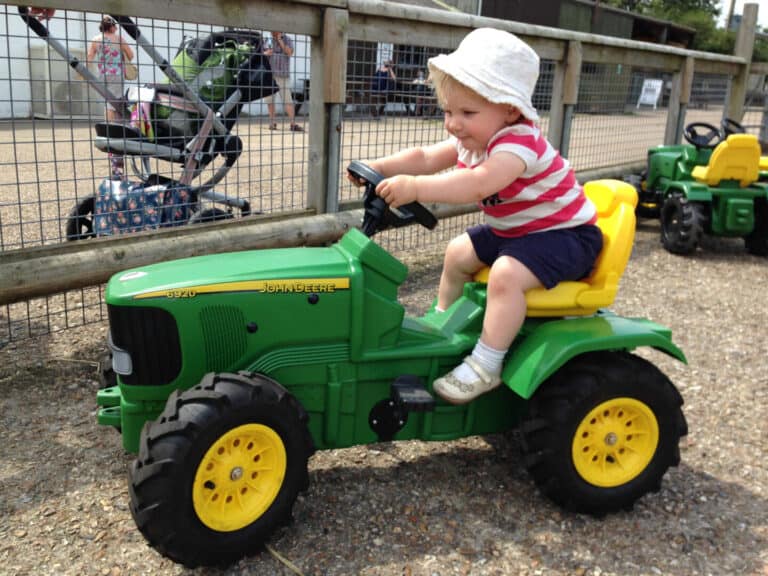 Toddler on toy tractor at Longdown Activity Farm