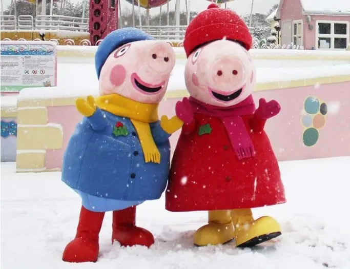 Peppa Pig and George dress in winter coats and standing in snow