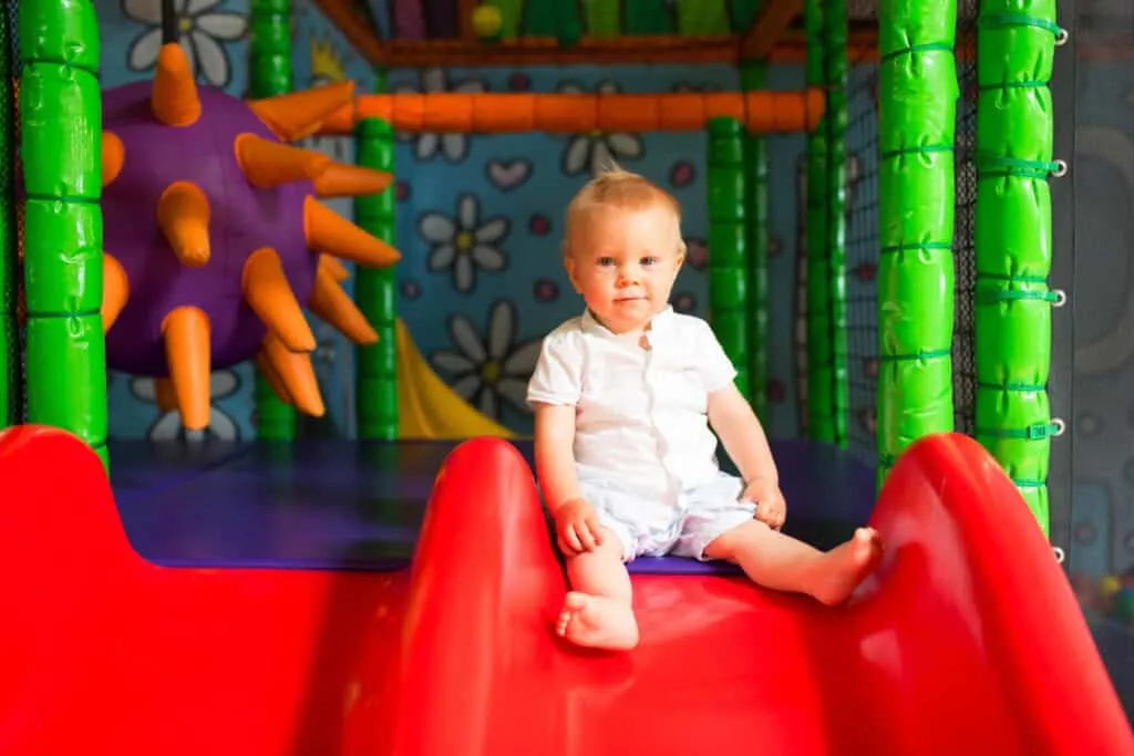 Little boy playing in childrens playground indoors