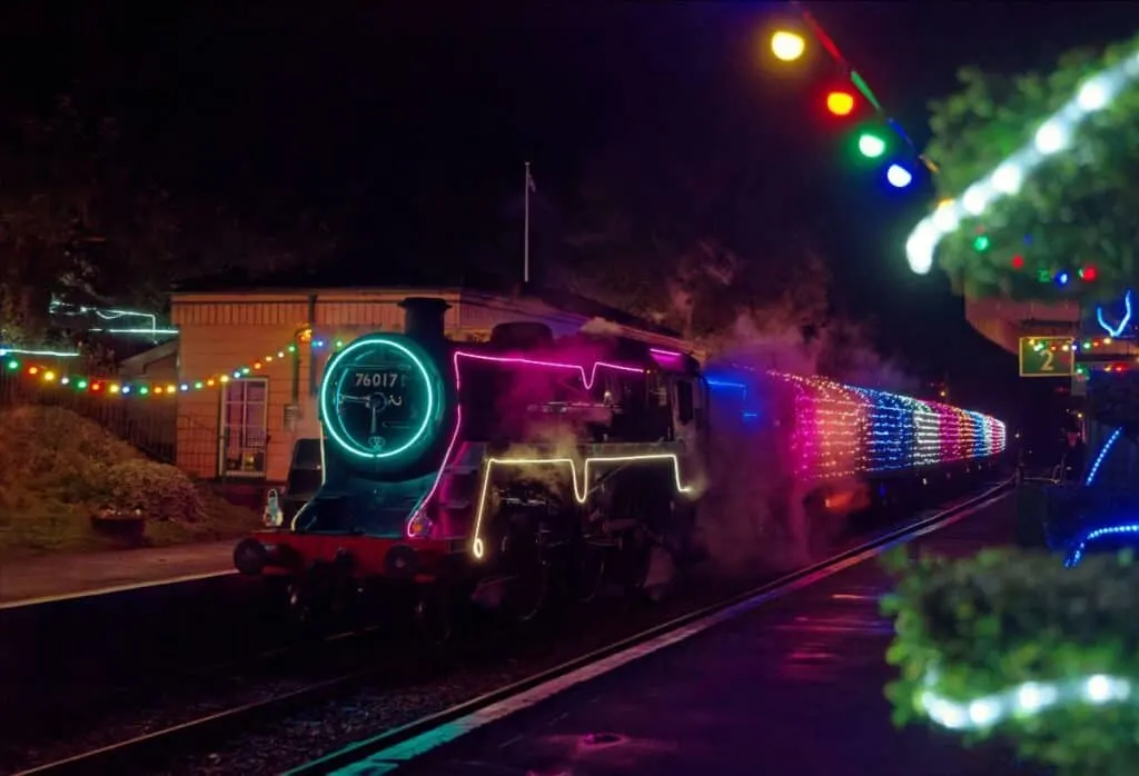 Steam train and station covered in lights