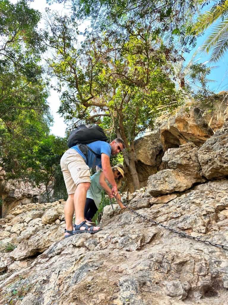 My Tin Box and out seven-year-old hold a chain drilled into a rock face as they climb down