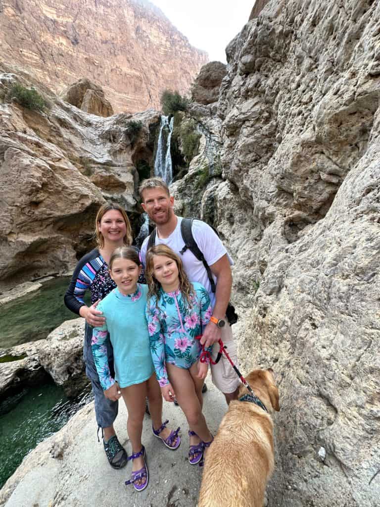Our family stood in front of the Mabim Waterfall in Wadi Tiwi.