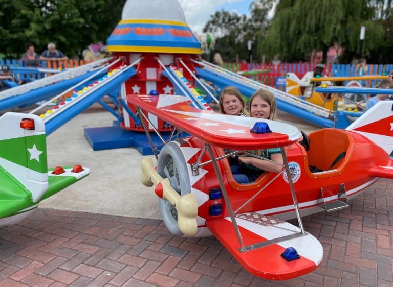 Kids on plane ride at theme park