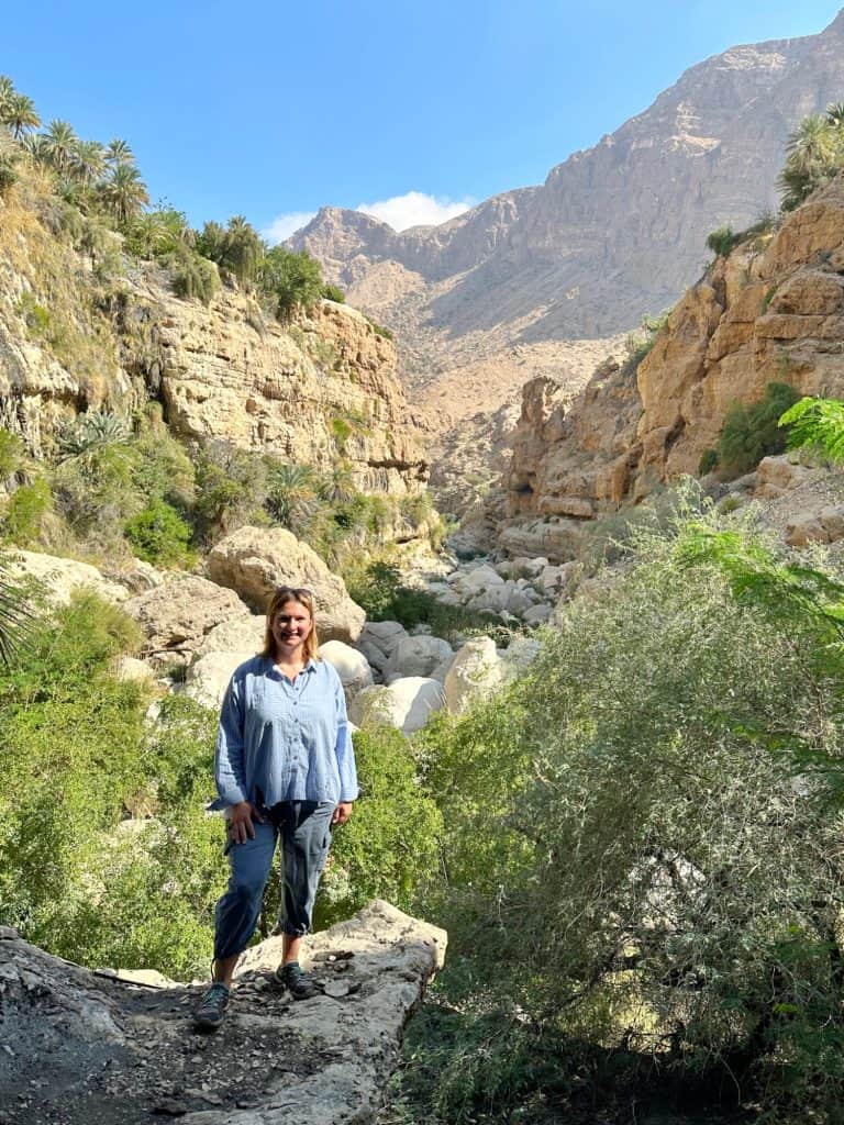 Me in Wadi Tiwi canyon just before the pools where we swam. Behind me is a rocky canyon with plenty of trees and greenery growing