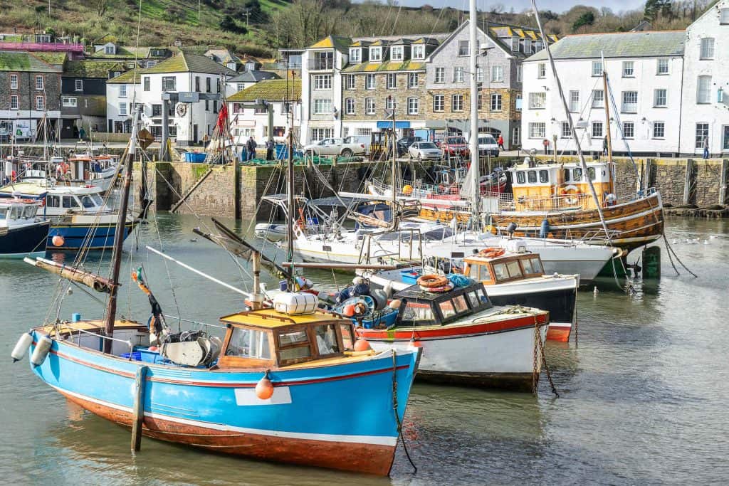 Colourful fishing boats bobbing in the harbour of the fishing village of Mevagissey in Cornwall
