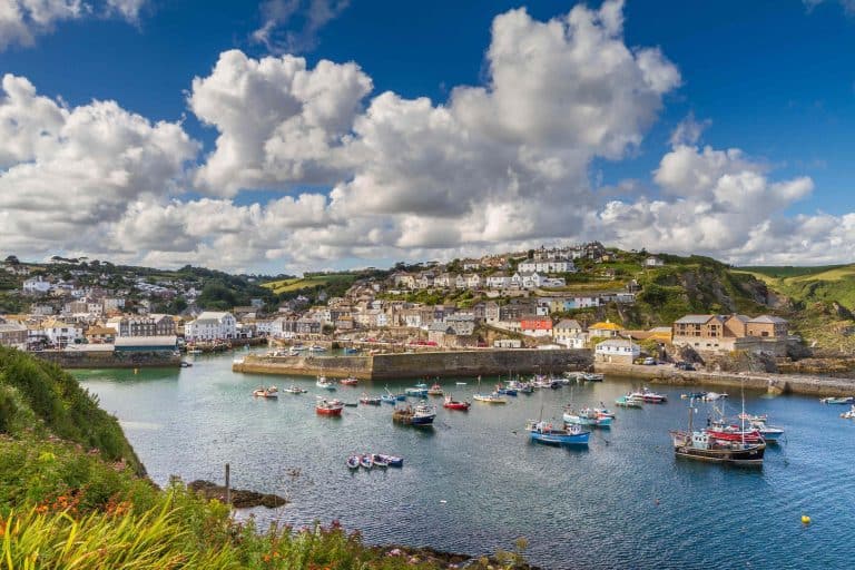 A view across Cornish countryside towards th fishing village of Mevagissey in Cornwall