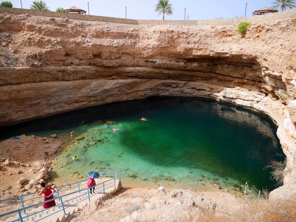 People walking down to and swimming in Bimmah Sinkhole between Muscat and Sur in Oman