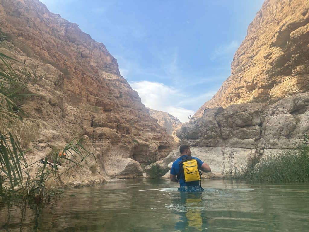 Mr Tin Box wades into the first turquoise pool in Wadi Shab.