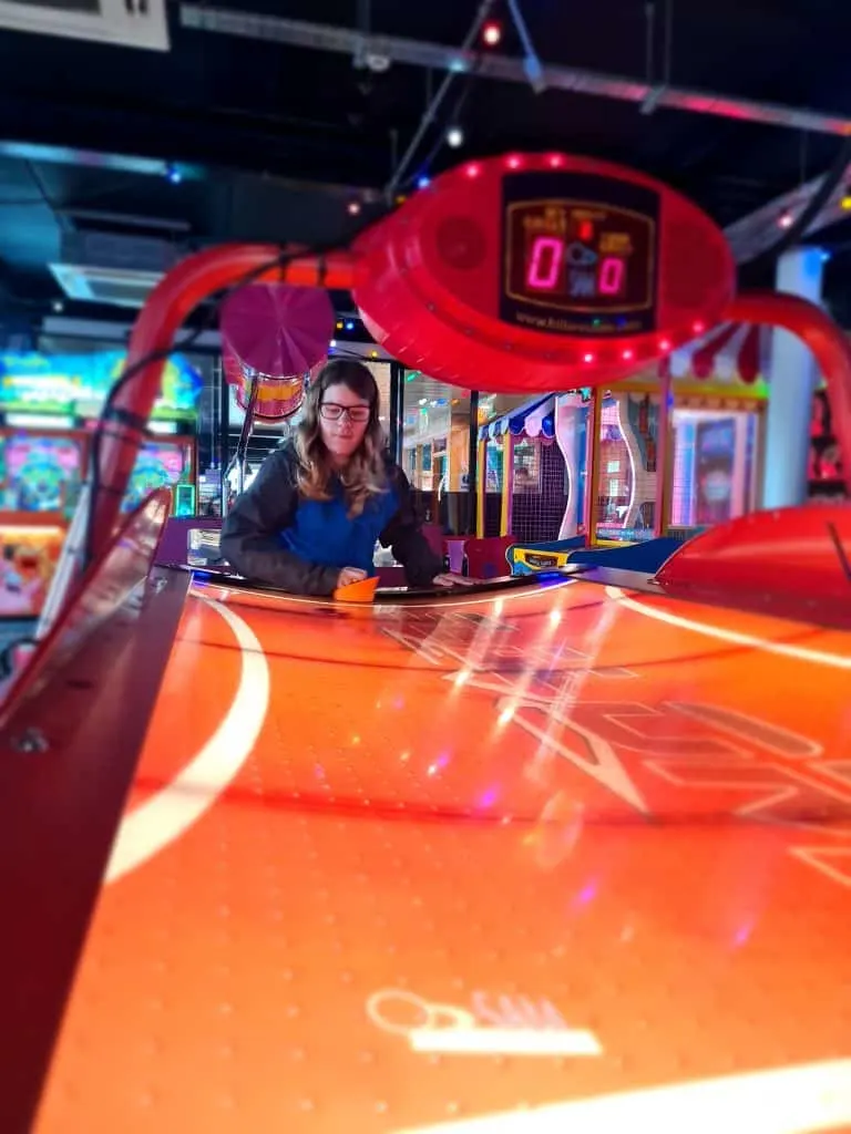 Kyle playing Air hockey in amusements
