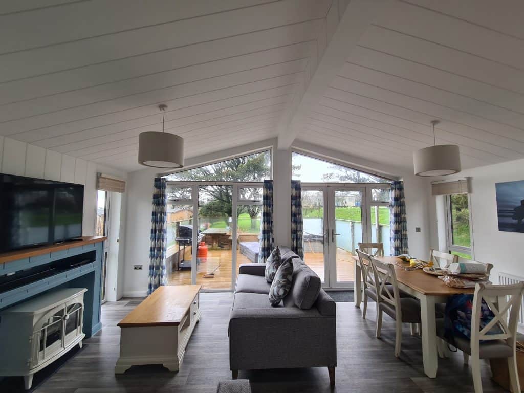 Inside light and airy lodge looking towards the decking through double patio doors
