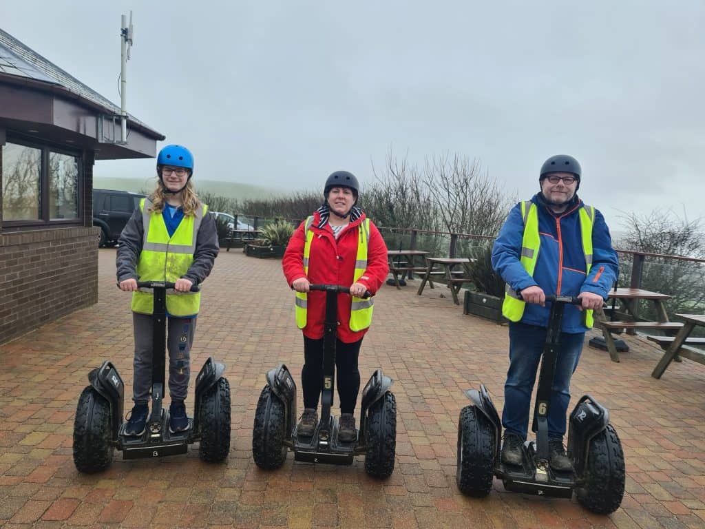 The Heath family on there Segways wrapped up on a dull wet day