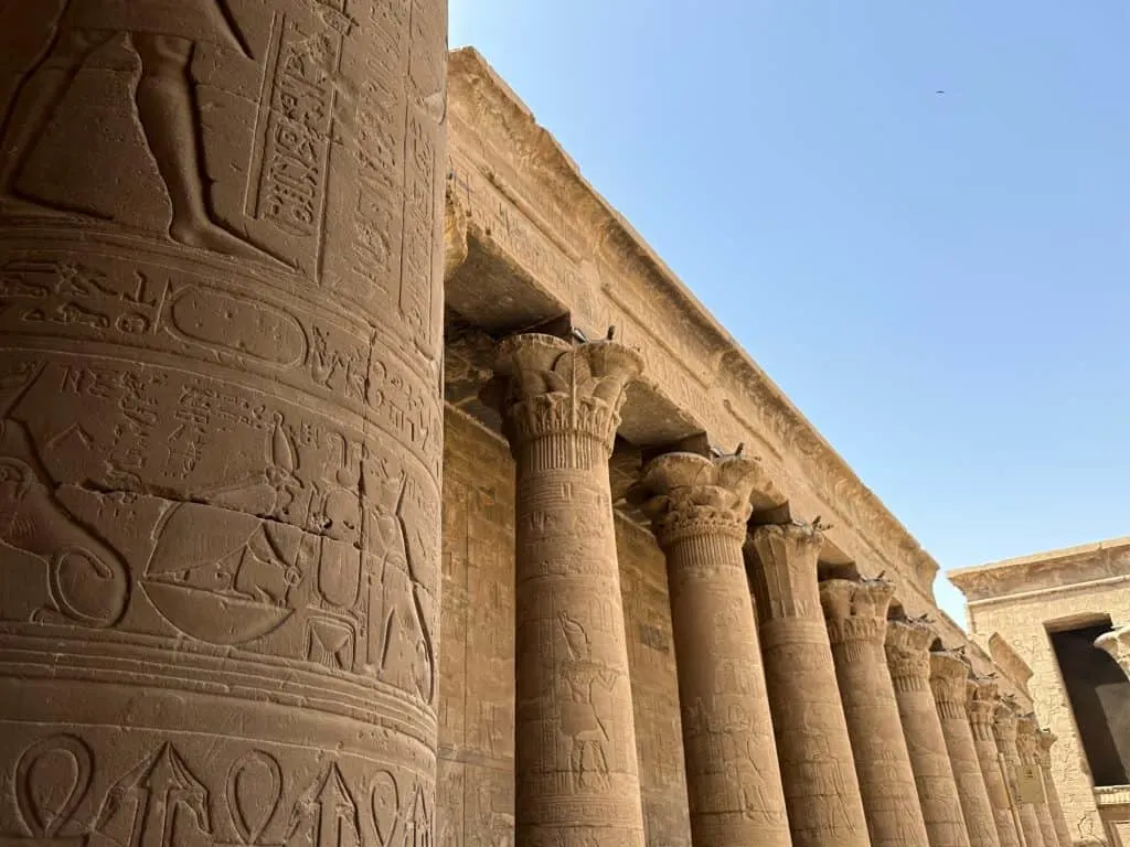 Columns decorated with hieroglyphs in the outdoor courtyard of Edfu temple