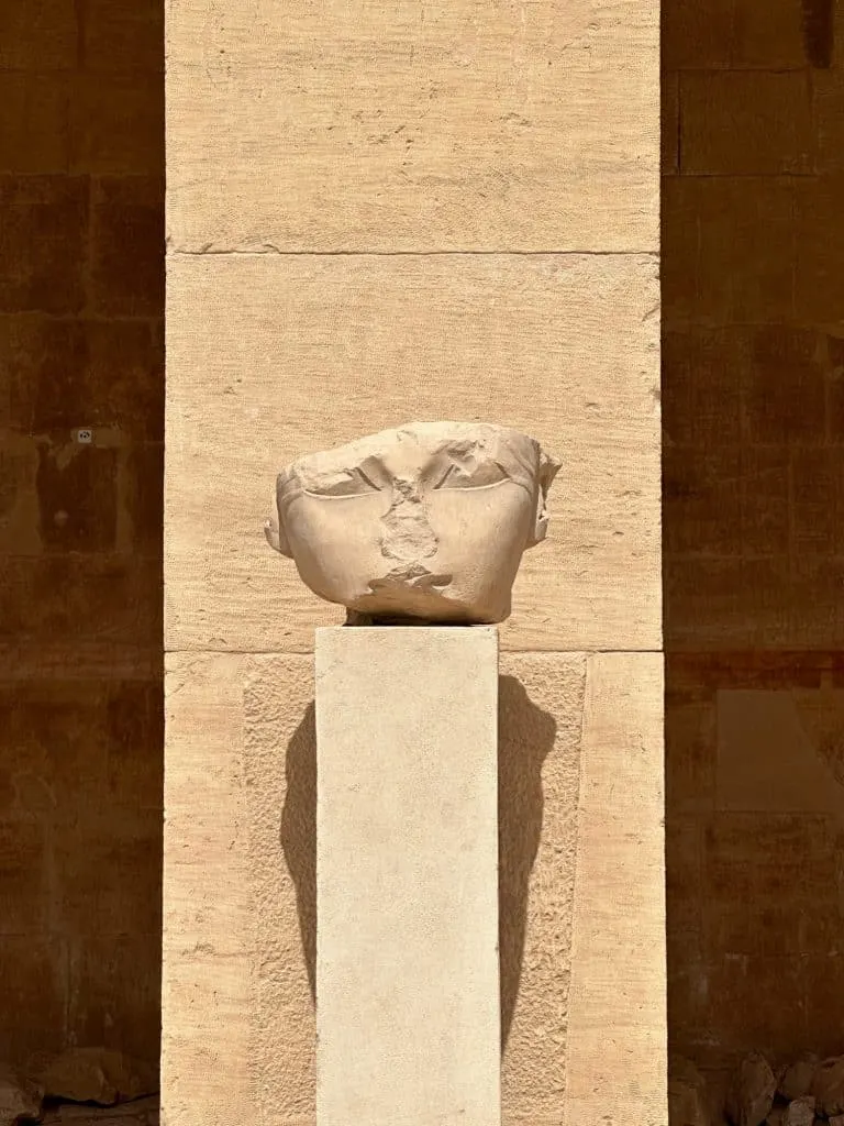 The severed head of a statue of Hatshepsut on a pillar