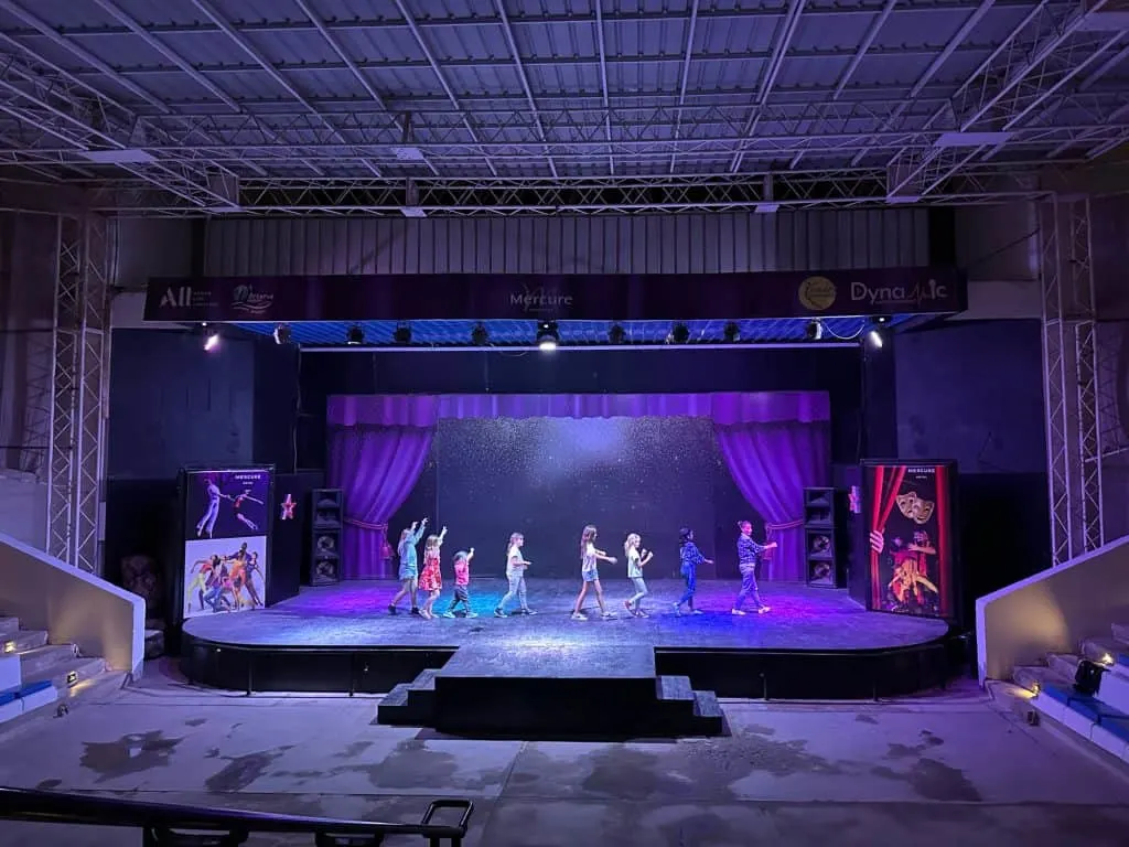 Children follow entertainer in a train across a stage in the Mercure Hotel ampitheatre