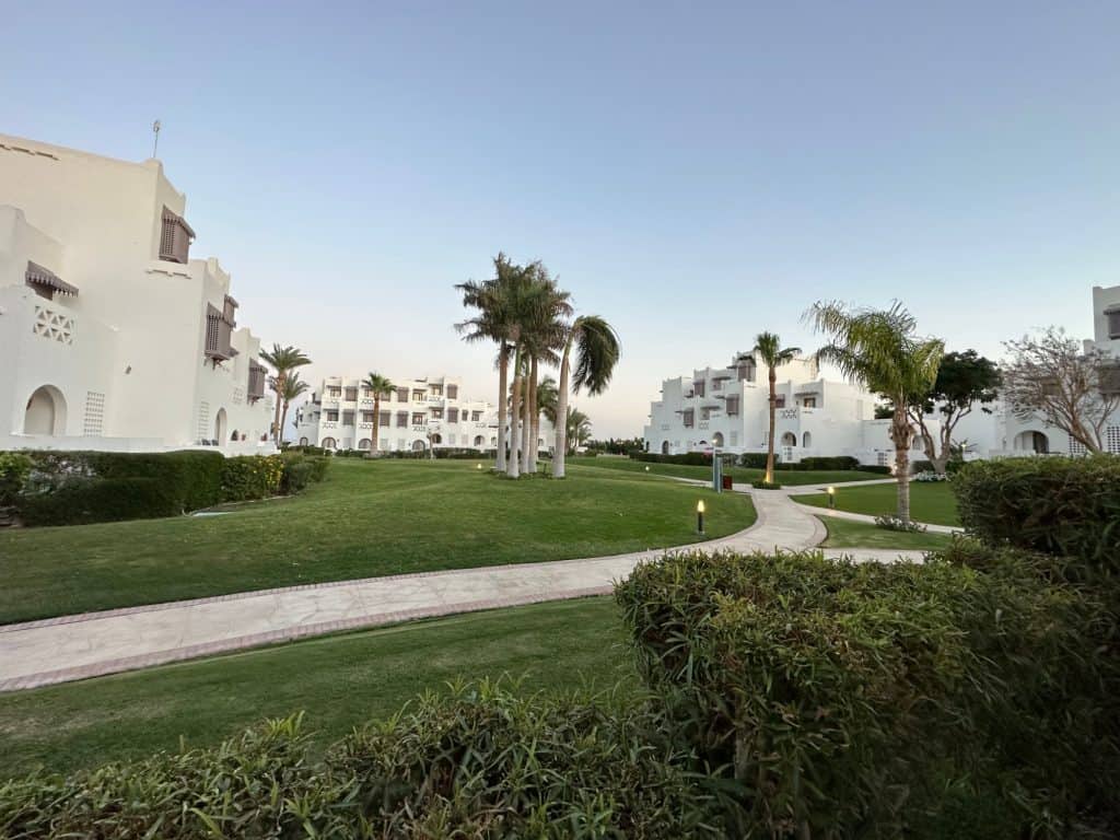 A view of the white washed low rise accommodation at Mercure Hurghada. The three-storey villas are arranged around grassy areas