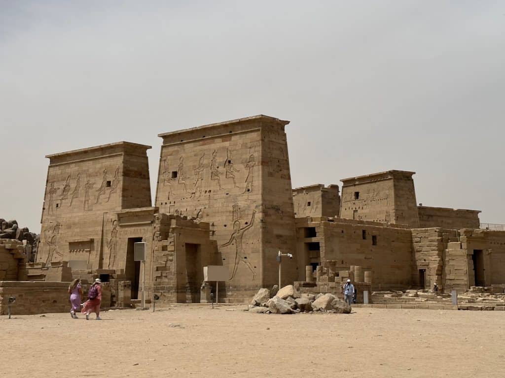 The front of the Temple of Philae which has high walls covered in hieroglyphs
