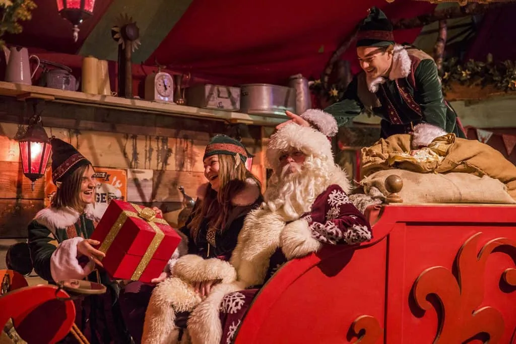 Father Christmas and elves in a festive grotto at the Eden Project