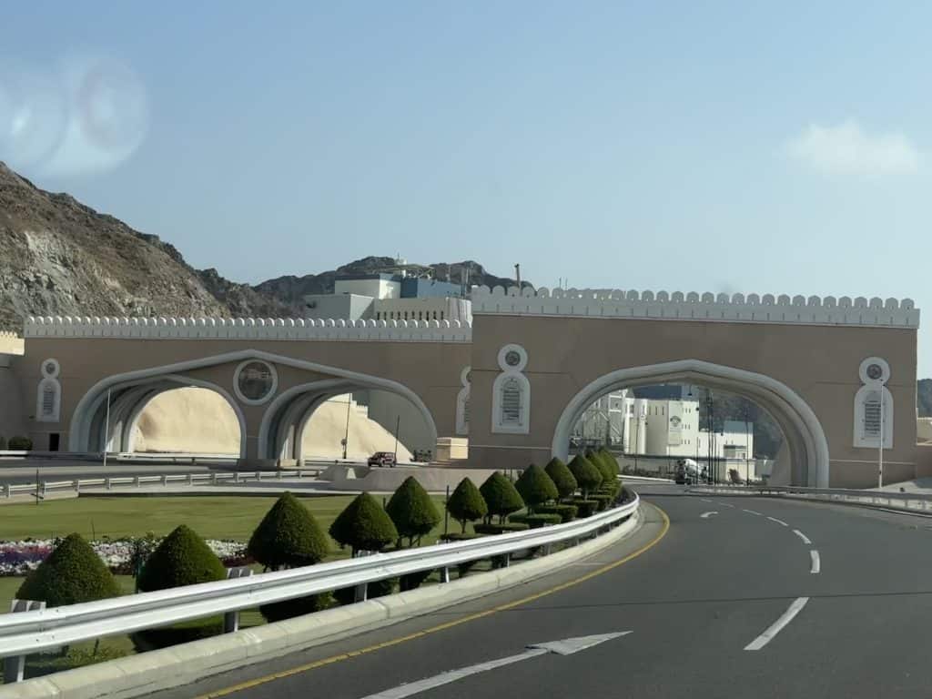 Picture of the Old Town Gates of Muscat taken from the front seat of our car as we drive towards them