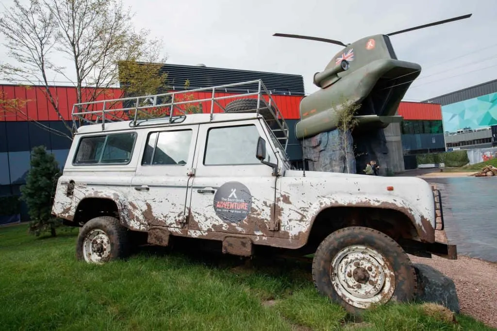 Mud covered 4x4 vehicle in front of the Bear Grylls Adventure building in Birmingham