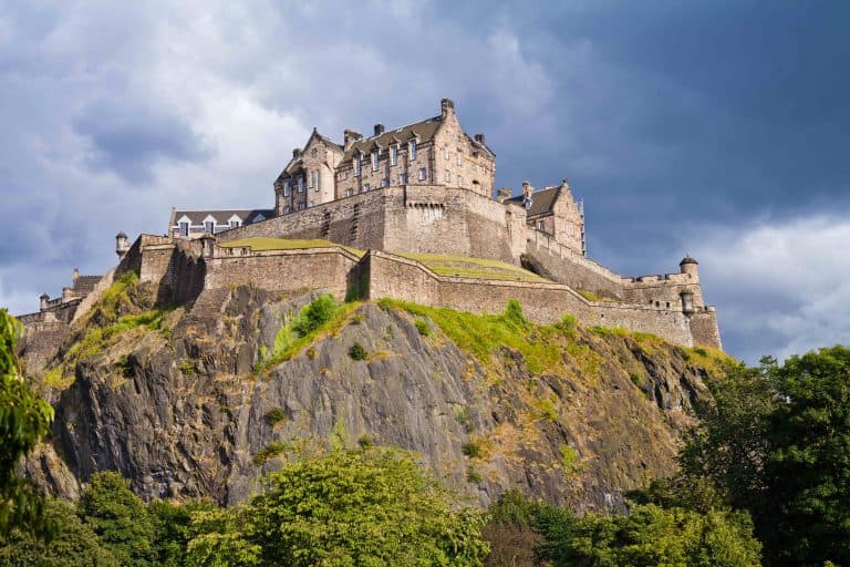 View of Edinburgh Castle from below against a stormy sky