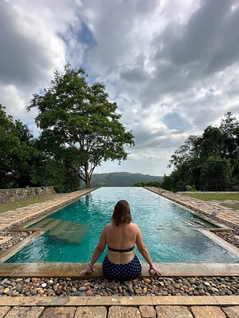 Claire sat on the edge of the infinity pool at Koslanda