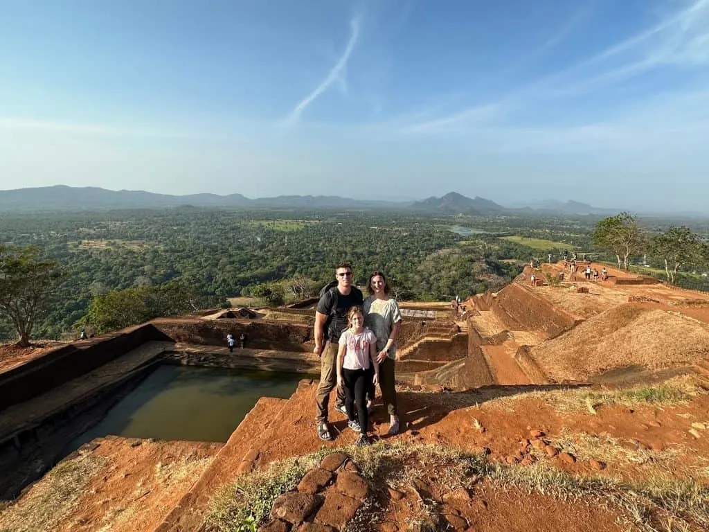Family at the top of Sigiriya ancient palace complex with views of the jungle below