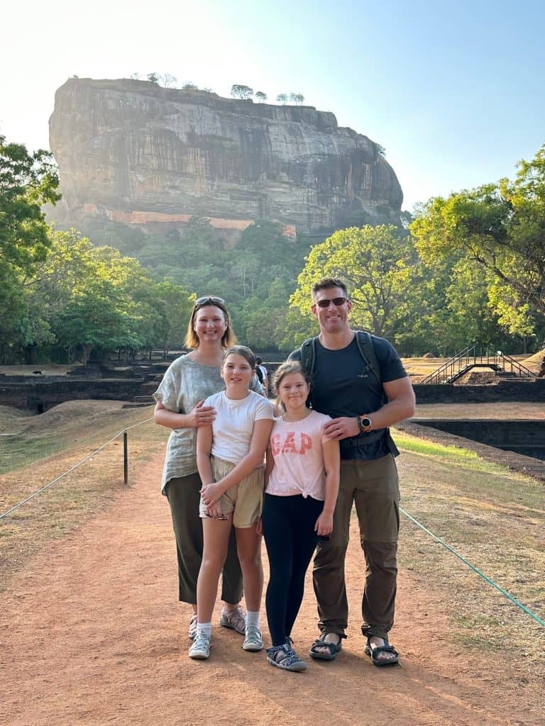 Family pose with Sigiriya rock in background