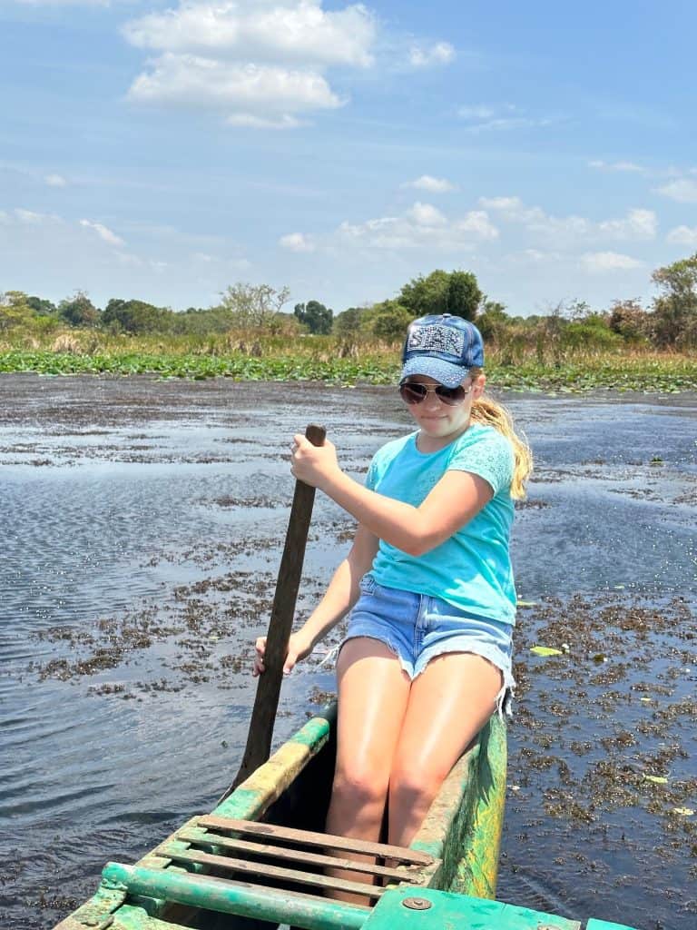 Ten year old say in the back of a kayak paddling on Hiriwidunna lake