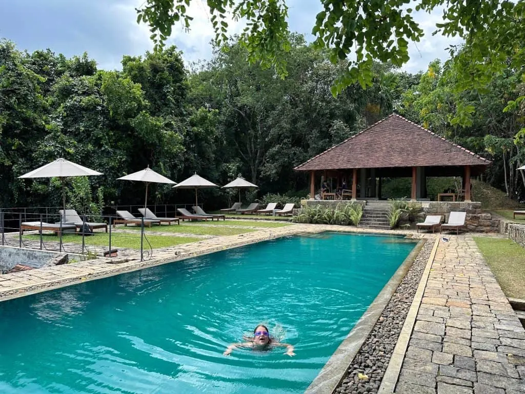 Our eight year old swimming in the pool at Koslanda. Behind her is a pool pavilion and seating