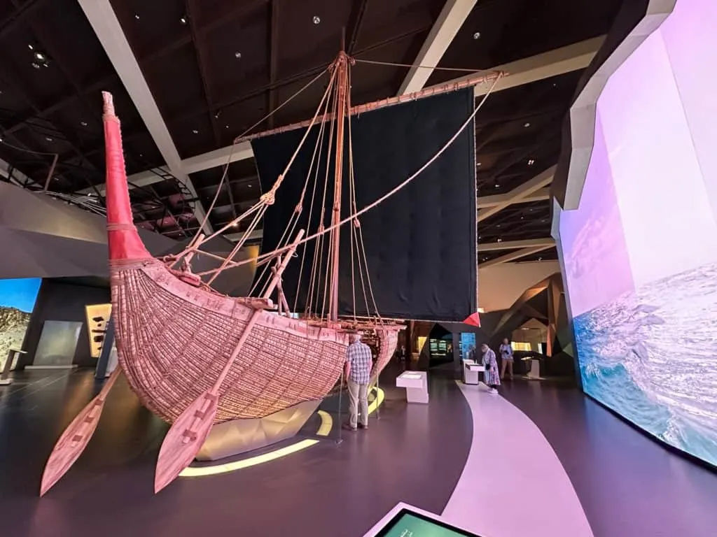 A recreated Megan era ship inside Oman Across the Ages Museum. It is made of wood and bales of straw