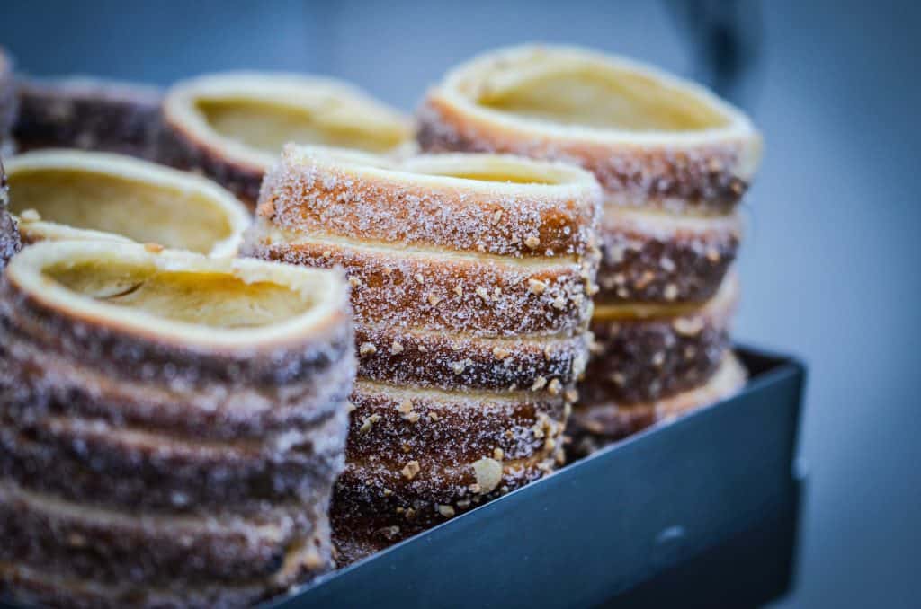 Traditional chimney cakes - twists of doughnut like pastry covered in sugar and nuts