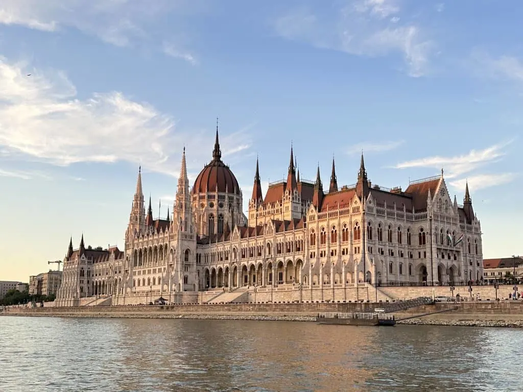 A view of the Hungarian Parliament building from the Danube River at sunset