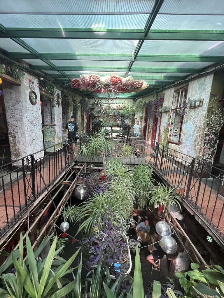 A balcony in a Ruin Bar decorated with plants and lighting