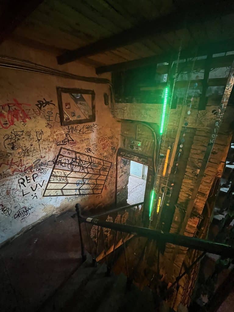A stairwell in a ruin bar covered in graffiti