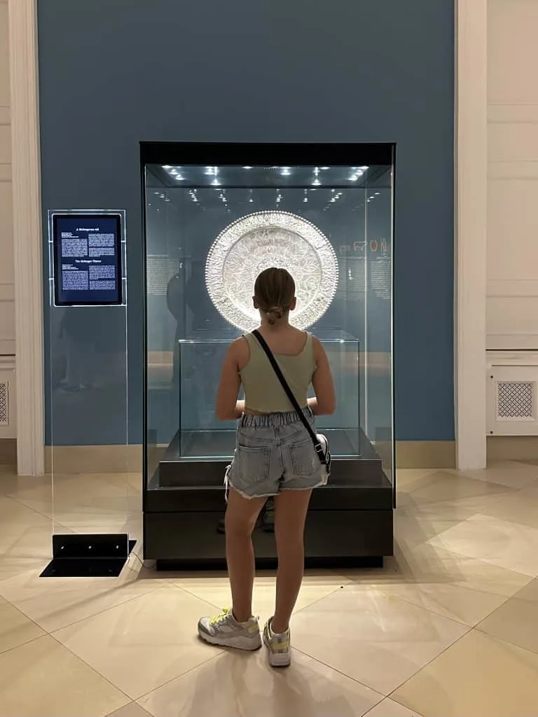 Our ten-year-old stood in front of a glass cabinet looking at a silver plate inside