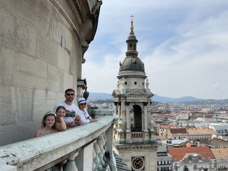 Mr Tin Box, his mum and out girls stood on the panoramic viewing platform at the top of St Stephen's Basilica. There's a view of the city behind them