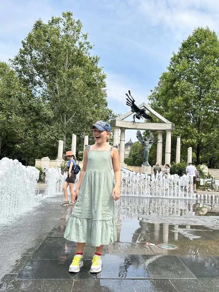 Our 10-year-old daughter enjoying water foundations in a square in Budapest. The jets come up randomly to surprise you