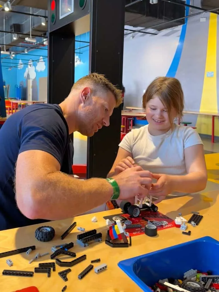 Mr Tin Box making a LEGO racing car with our eight-year-old in the Build & Test attraction at LEGOLAND Dubai