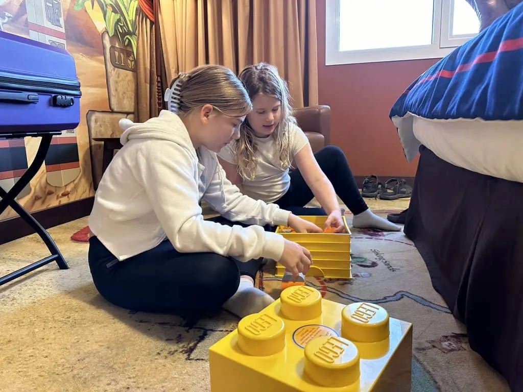 Our eight and 11-year-old playing with the box of Duplo in our hotel room